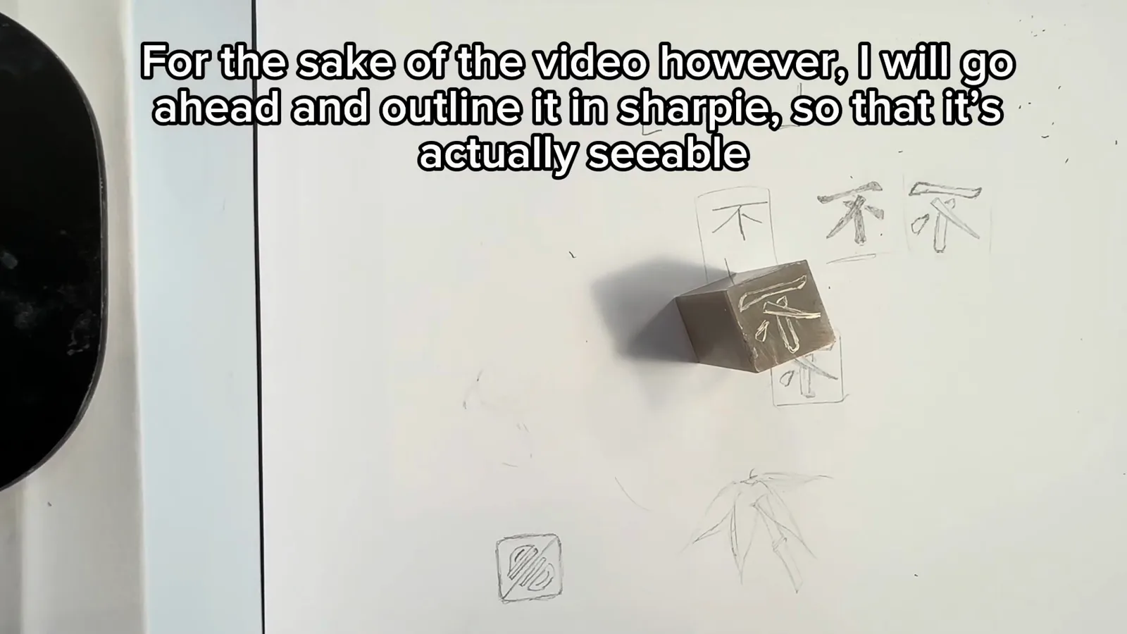 The flipped character pattern being rubbed from tracing paper onto the flat face of a soft Qingtian carving stone with transfer ink